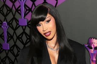 Cardi B at the Hollywood Unlocked Impact Awards, wearing a sleek black outfit with straight, long hair and a necklace